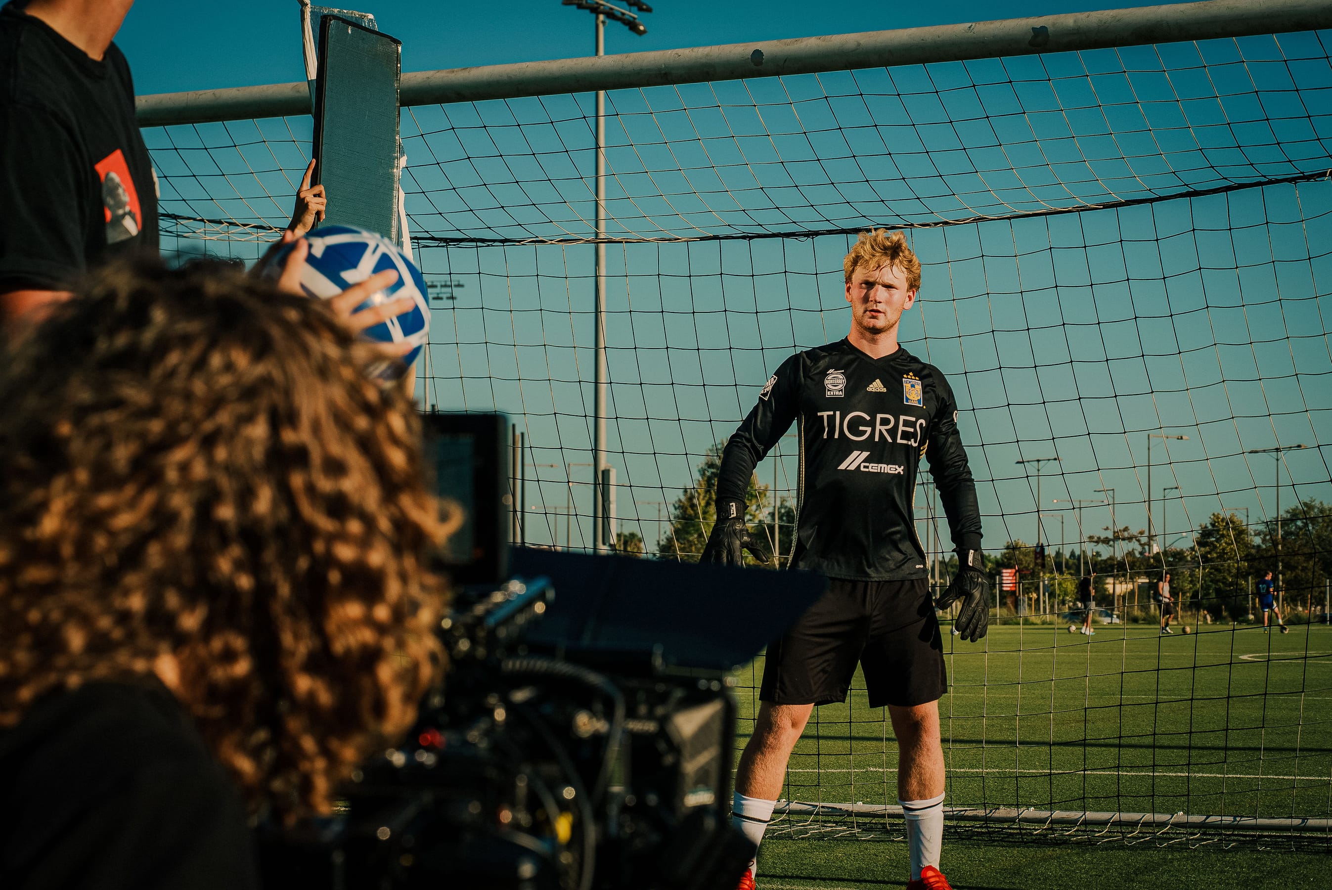 Soccer goalkeeper on set in front of the net during a shoot